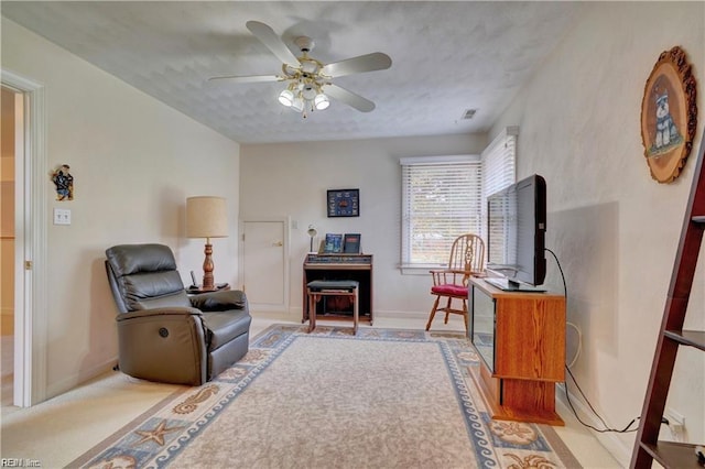 sitting room featuring ceiling fan and a textured ceiling