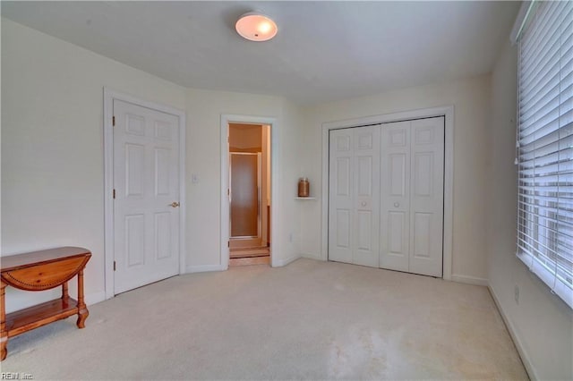 bedroom featuring light carpet and a closet