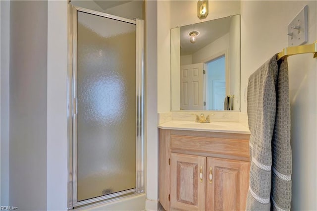 bathroom featuring vanity and an enclosed shower