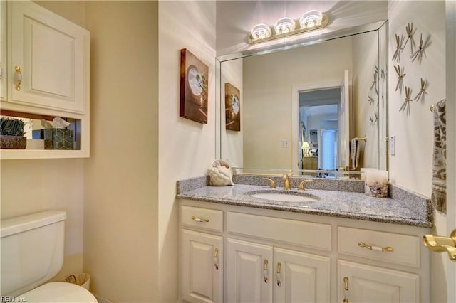 bathroom featuring toilet and vanity