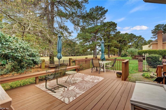 wooden deck with a lawn