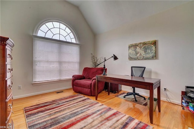 office featuring vaulted ceiling and wood-type flooring