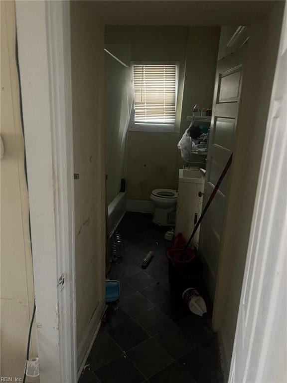 bathroom featuring shower / bath combination and toilet