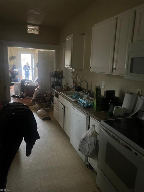 kitchen with sink, white cabinets, and white appliances