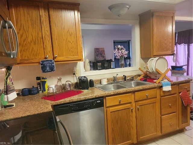 kitchen featuring dishwasher, tasteful backsplash, sink, range with electric stovetop, and light tile patterned floors