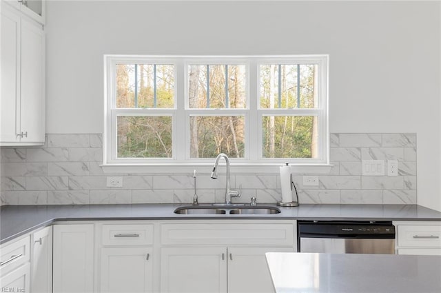 kitchen featuring sink, stainless steel dishwasher, white cabinets, and decorative backsplash