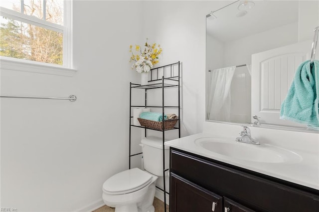 bathroom featuring vanity, toilet, and walk in shower