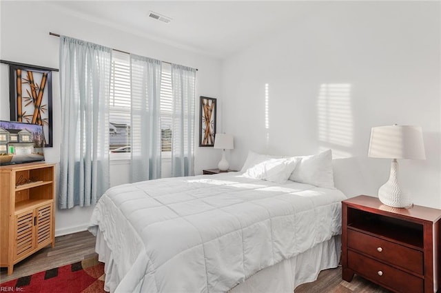 bedroom with dark hardwood / wood-style floors