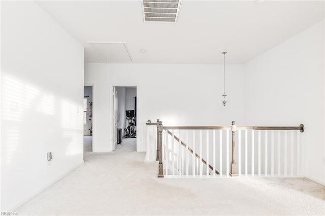 corridor with light colored carpet