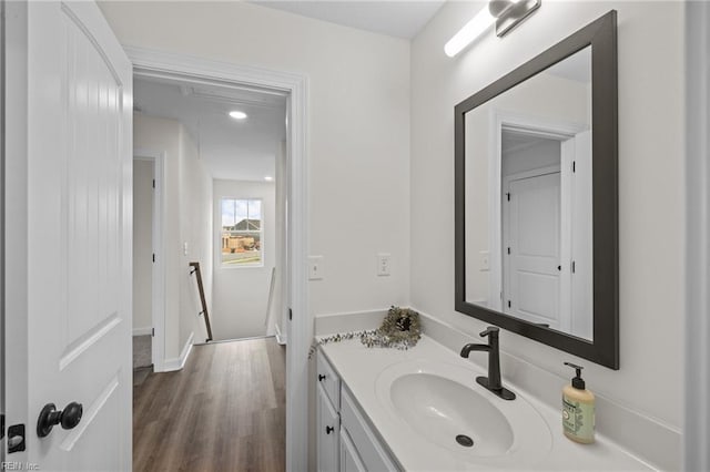 bathroom with hardwood / wood-style floors and vanity