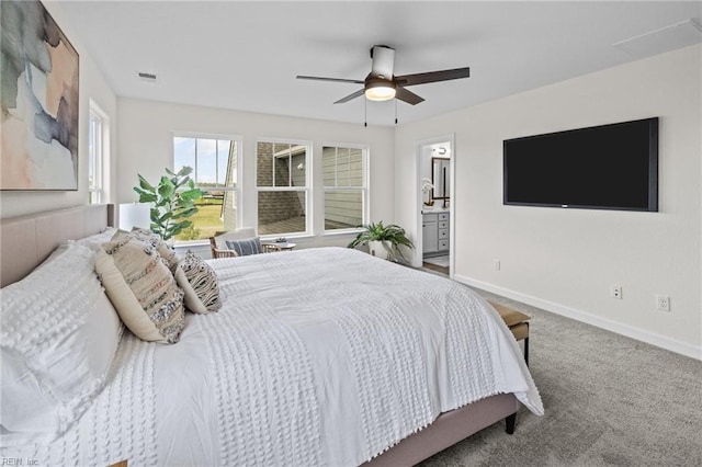 carpeted bedroom with ceiling fan and ensuite bath