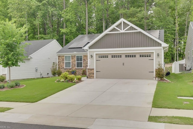 craftsman inspired home featuring a front yard, a garage, and solar panels