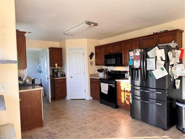 kitchen featuring black appliances and a textured ceiling