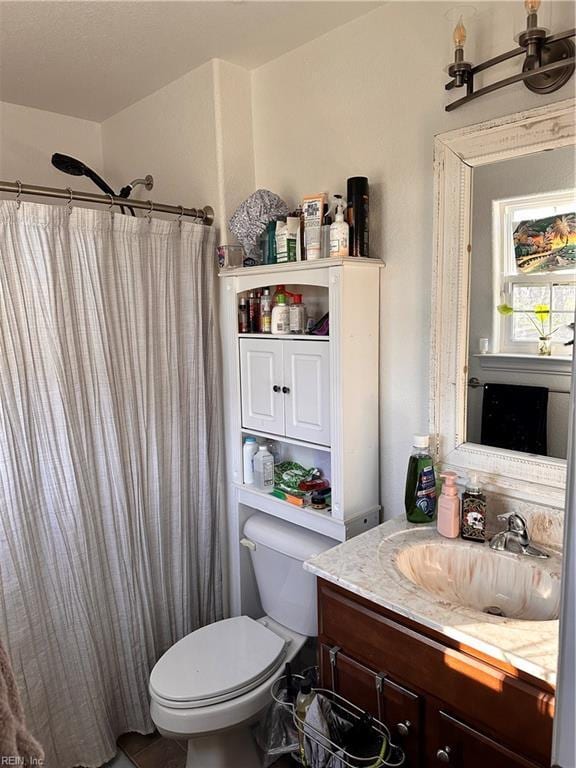 bathroom with vanity, curtained shower, and toilet