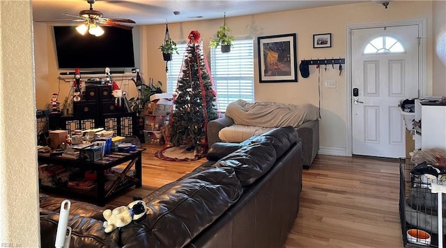 living room with ceiling fan, a healthy amount of sunlight, and hardwood / wood-style floors