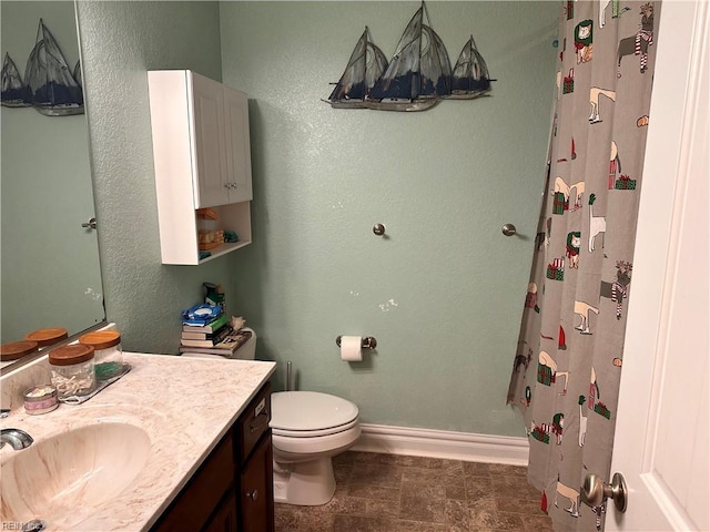 bathroom featuring vanity, toilet, and a shower with shower curtain