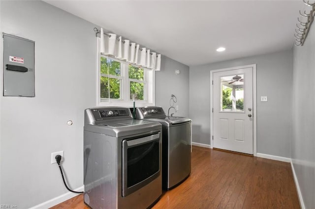 laundry room featuring dark hardwood / wood-style floors, washer and dryer, and electric panel