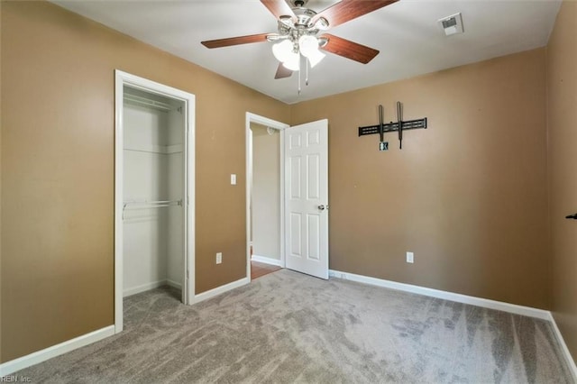 unfurnished bedroom featuring ceiling fan, a closet, and light carpet