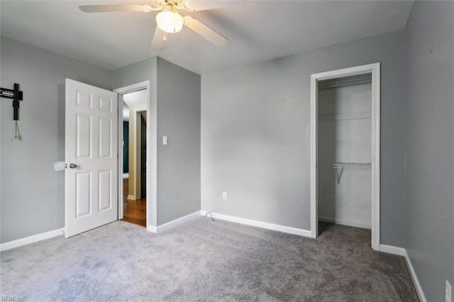 unfurnished bedroom with ceiling fan, carpet, and a closet