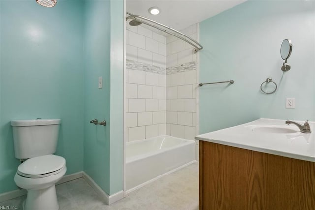 full bathroom featuring toilet, vanity, and tiled shower / bath