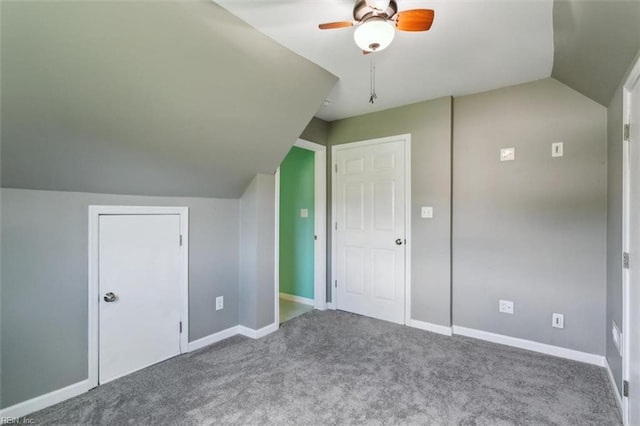 additional living space with ceiling fan, vaulted ceiling, and carpet flooring