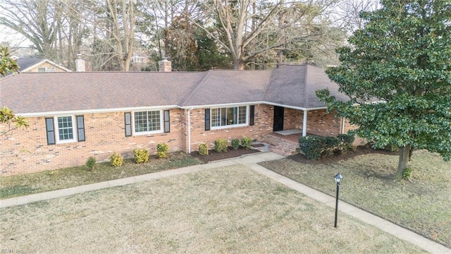 ranch-style home with a front lawn