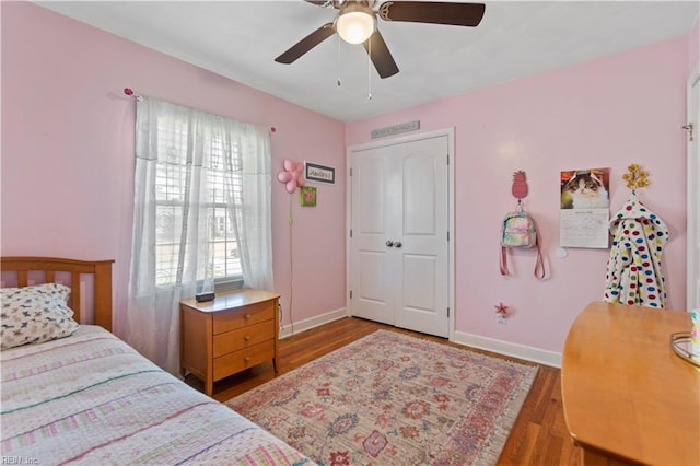 bedroom featuring ceiling fan, a closet, and hardwood / wood-style flooring