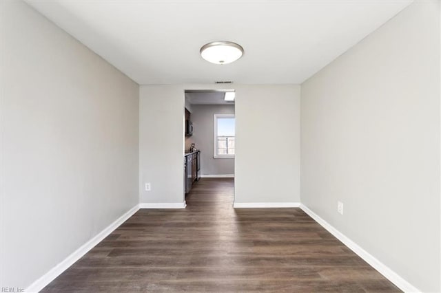 spare room featuring dark wood-type flooring