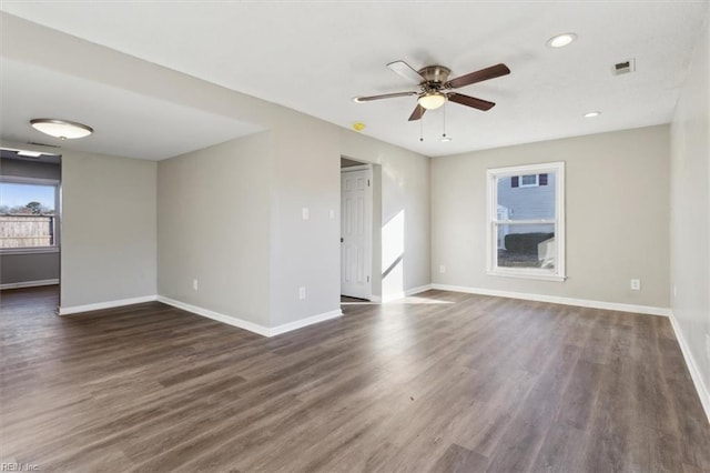 spare room with ceiling fan and dark hardwood / wood-style flooring