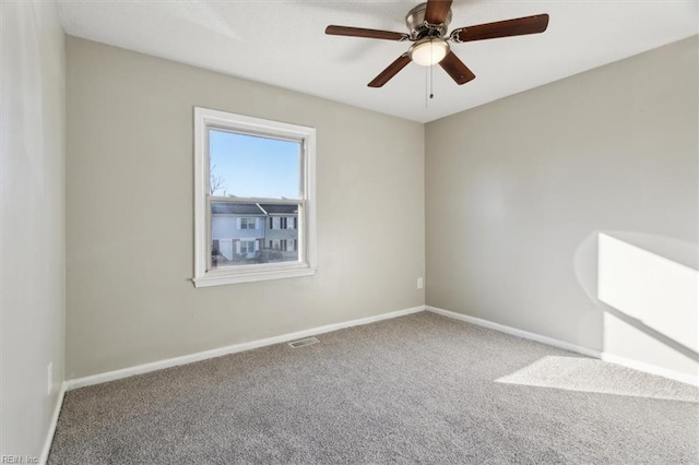 unfurnished room featuring ceiling fan and carpet flooring