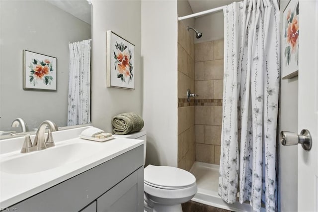 bathroom with toilet, vanity, and a shower with curtain