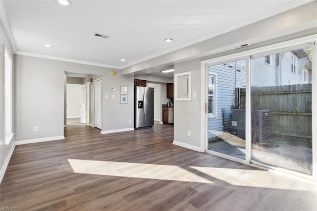 unfurnished room with dark wood-type flooring and crown molding