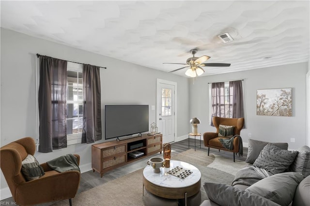 living room featuring light hardwood / wood-style flooring and ceiling fan