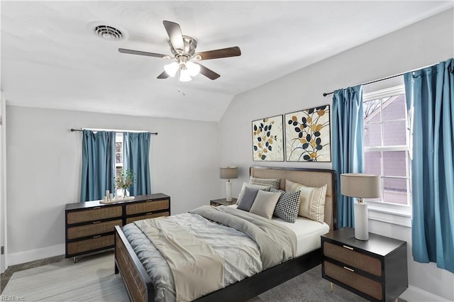 bedroom with multiple windows, lofted ceiling, and ceiling fan