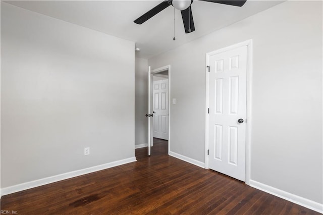 unfurnished bedroom featuring dark wood-type flooring and ceiling fan