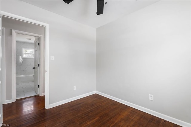 spare room with ceiling fan and dark wood-type flooring