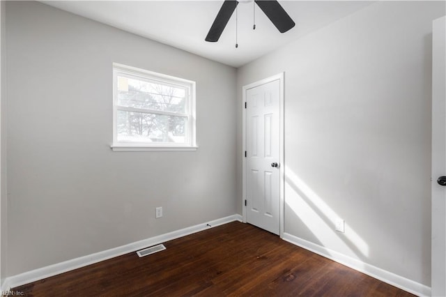 spare room with ceiling fan and dark hardwood / wood-style floors