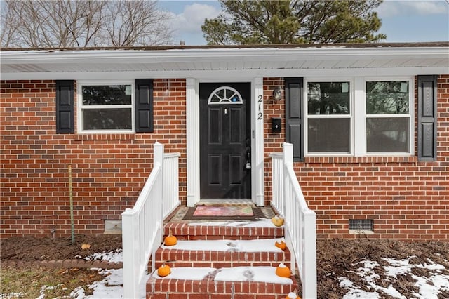 view of snow covered property entrance