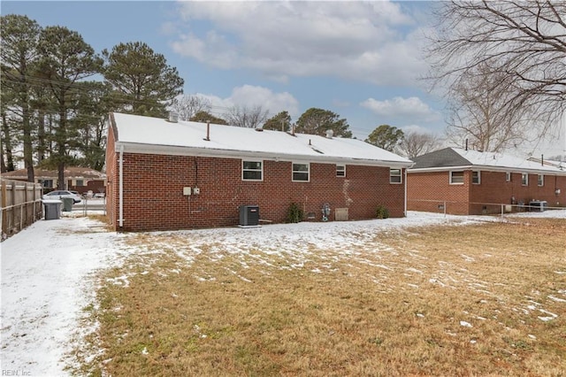 snow covered property featuring central AC unit