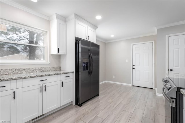 kitchen featuring light stone countertops, white cabinets, appliances with stainless steel finishes, and crown molding