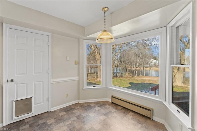 unfurnished dining area featuring a baseboard heating unit and a water view