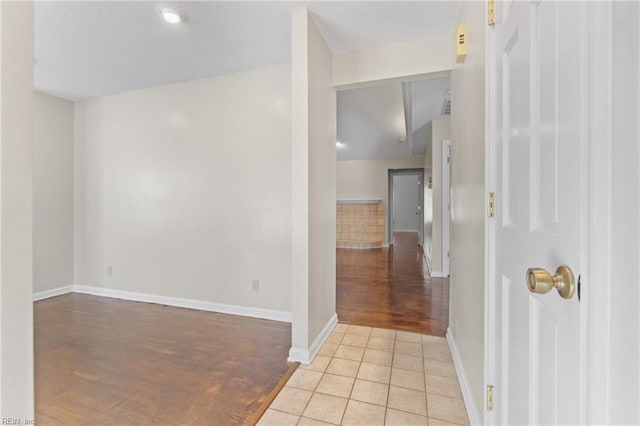 hallway featuring light tile patterned floors