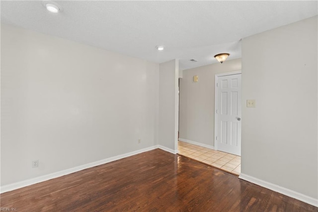 empty room with hardwood / wood-style floors