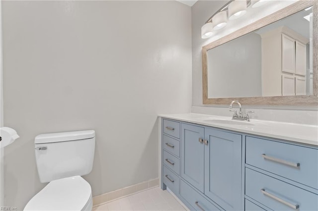 bathroom featuring toilet, vanity, and tile patterned flooring