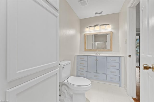 bathroom featuring toilet and vanity