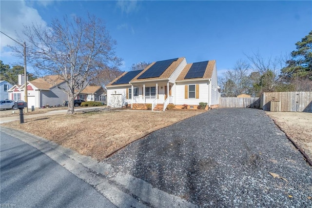 view of front of home featuring covered porch and solar panels