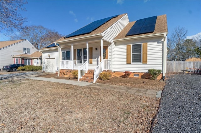 view of front of home with solar panels and covered porch