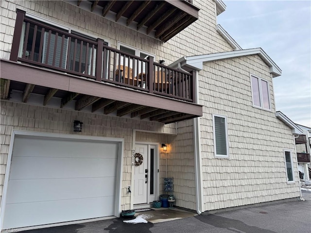 property entrance with a garage and a balcony