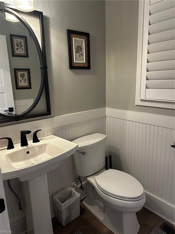 bathroom with sink, wood-type flooring, and toilet