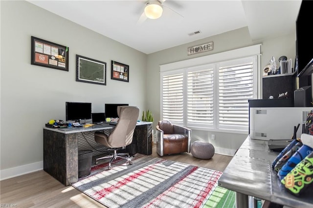 home office featuring light hardwood / wood-style floors and ceiling fan